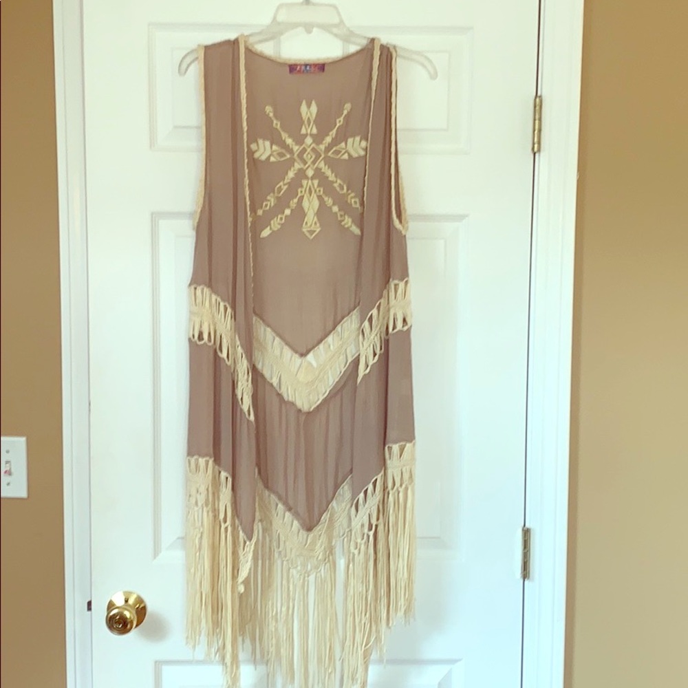 Sleeveless fringe and crochet cover up.